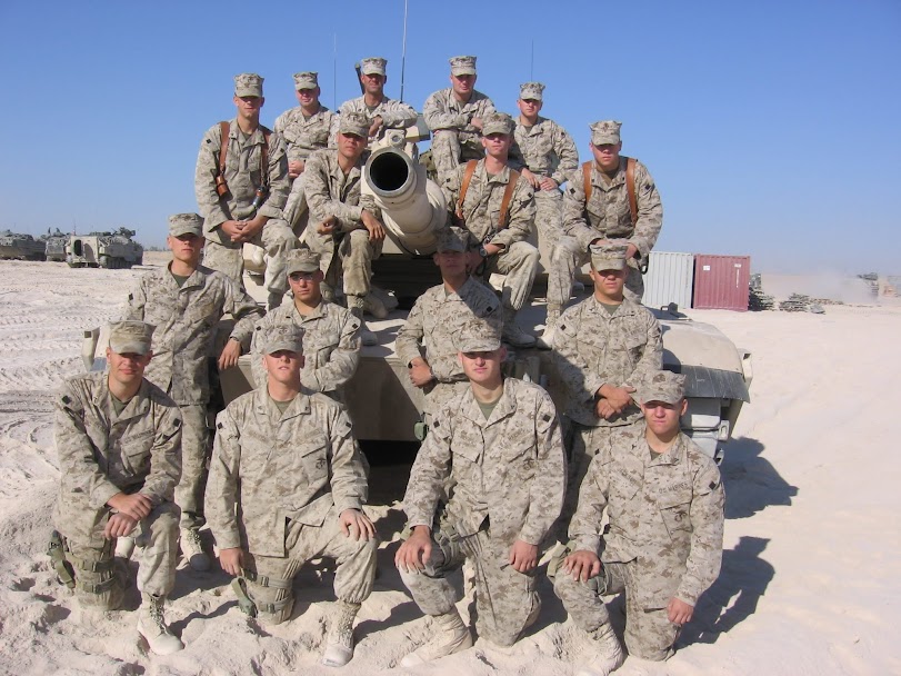 Marine Corps platoon posing with tank in Iraq